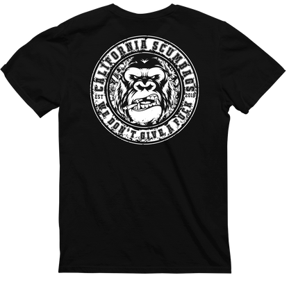 Introducing the CaliforniaScumbags Badge Of Honor - Black Heavyweight Tee, featuring a new logo on the back. The design depicts a grinning ape's face in the center, surrounded by the text "California Scumbags" and "We Don't Give a F*" along the border, with "EST 2016" at each side. Perfect for hardcore music fans.