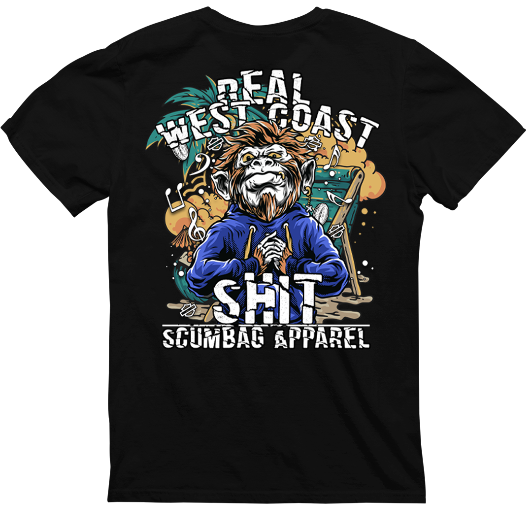 A black t-shirt with a graphic design on the back featuring an illustrated character dressed in a blue hoodie. Text above the illustration reads "REAL WEST COAST." Below it, in larger text, it says "SHIT" followed by "CaliforniaScumbags" at the bottom. The "Real West Coast Shit" is perfect for a hardcore punk vibe.